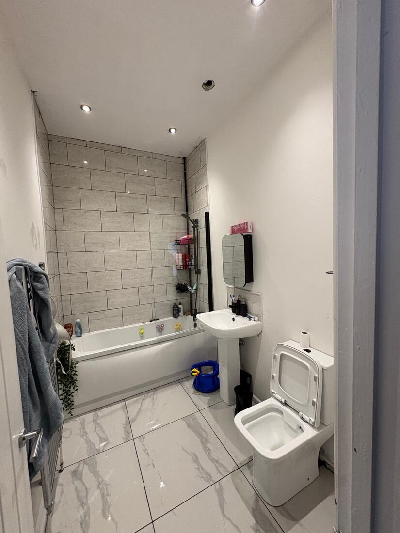 Finished bathroom with tiled walls and new electrics
